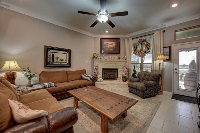 tiled living room with crown molding, ceiling fan, and a fireplace