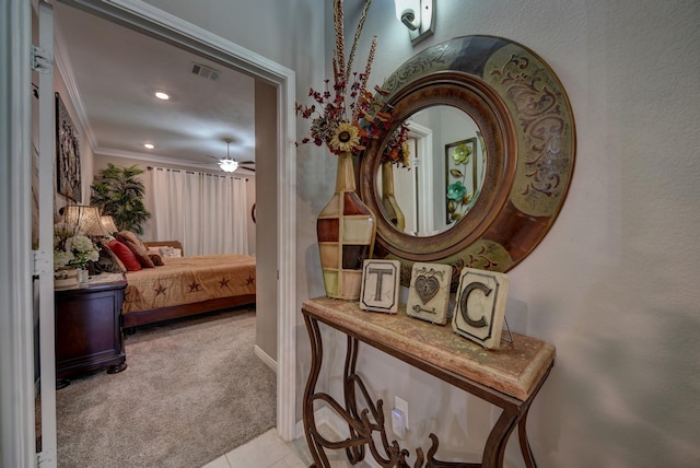 hall with crown molding and light carpet