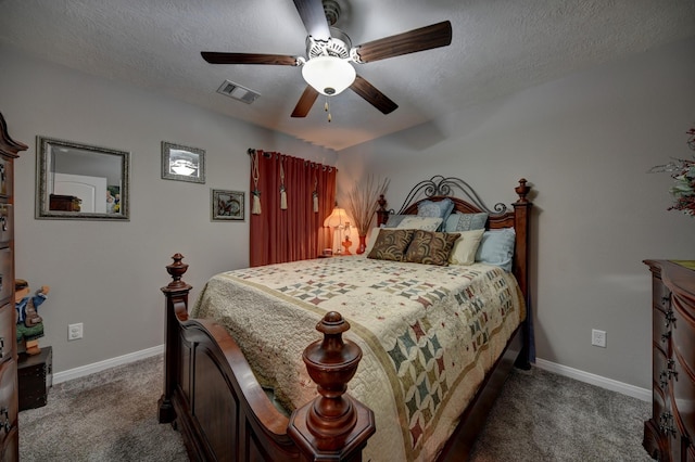 carpeted bedroom with ceiling fan and a textured ceiling