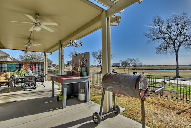 view of patio featuring a grill, ceiling fan, and a water view