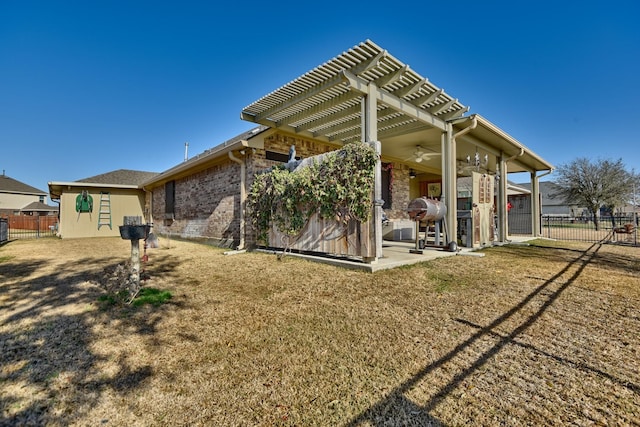 back of house featuring a patio, a lawn, ceiling fan, and a pergola