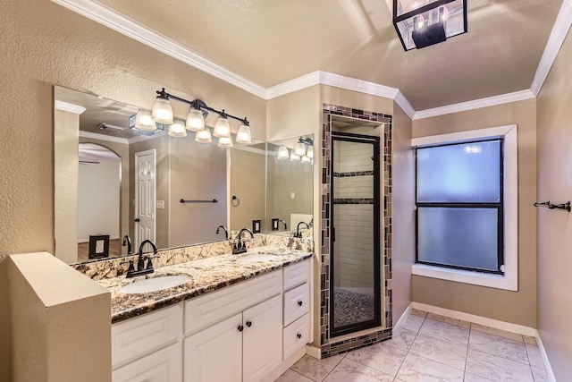 bathroom with an enclosed shower, vanity, and ornamental molding