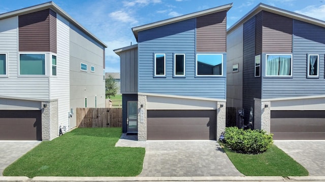 contemporary home with a garage and a front lawn