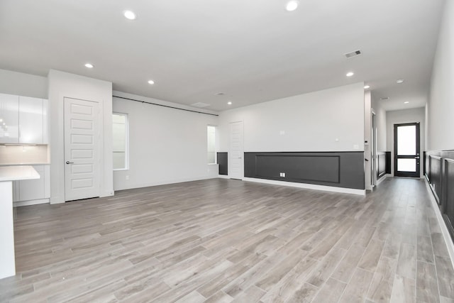 unfurnished living room featuring light hardwood / wood-style floors