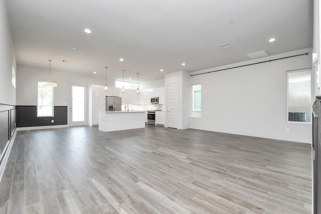 unfurnished living room with hardwood / wood-style flooring