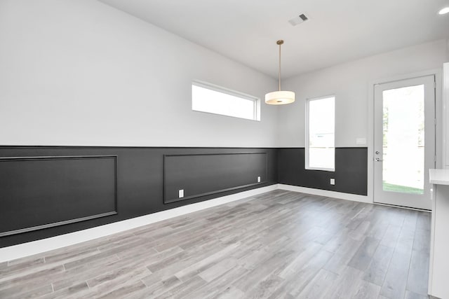 spare room with light hardwood / wood-style flooring