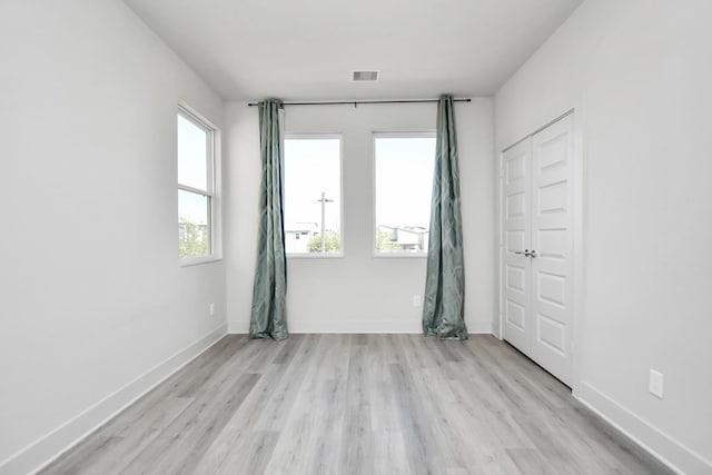 unfurnished room with light wood-type flooring