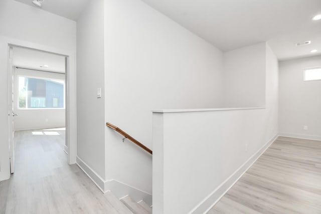 hallway with light hardwood / wood-style floors