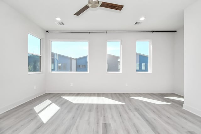 empty room featuring ceiling fan and light hardwood / wood-style floors