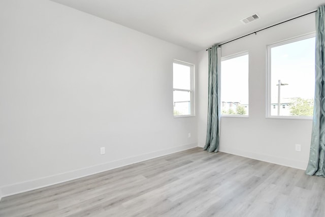 spare room with light wood-type flooring