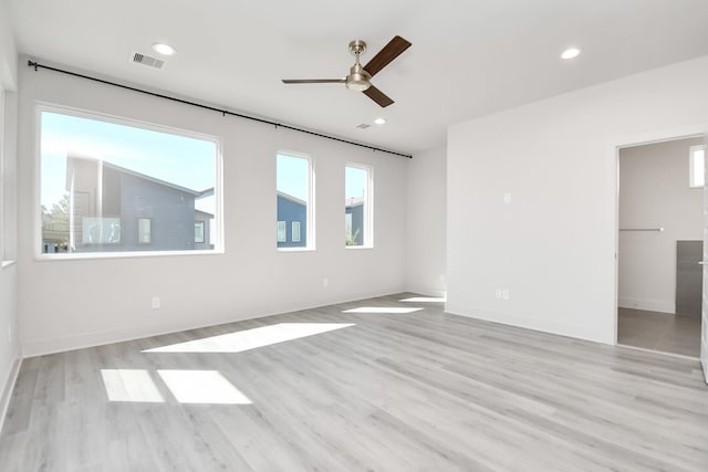 spare room with light hardwood / wood-style flooring and ceiling fan