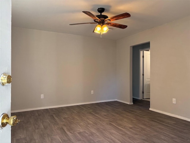 spare room with ceiling fan and dark hardwood / wood-style flooring