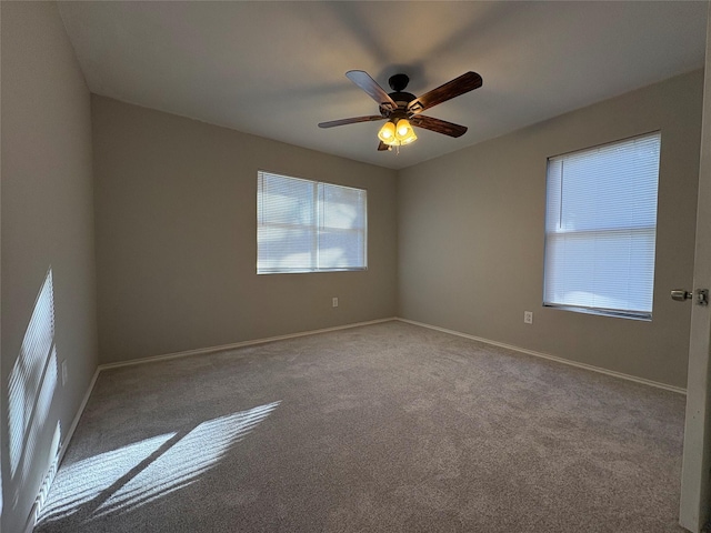 carpeted spare room with ceiling fan