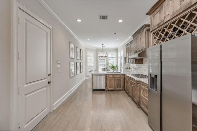 kitchen featuring appliances with stainless steel finishes, hanging light fixtures, ornamental molding, decorative backsplash, and kitchen peninsula