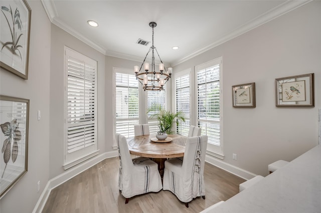 dining room with crown molding, wood-type flooring, and a wealth of natural light