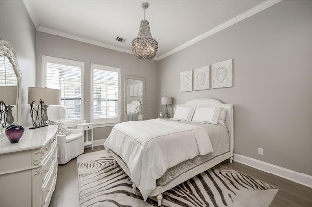 bedroom featuring dark wood-type flooring, ornamental molding, and a notable chandelier