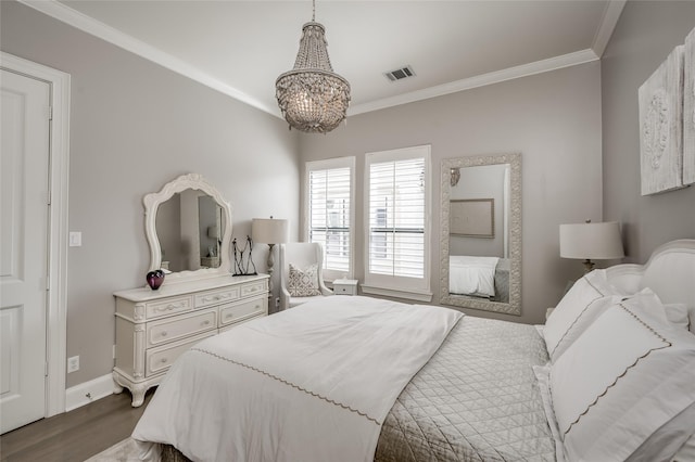 bedroom featuring crown molding, dark hardwood / wood-style floors, and a chandelier