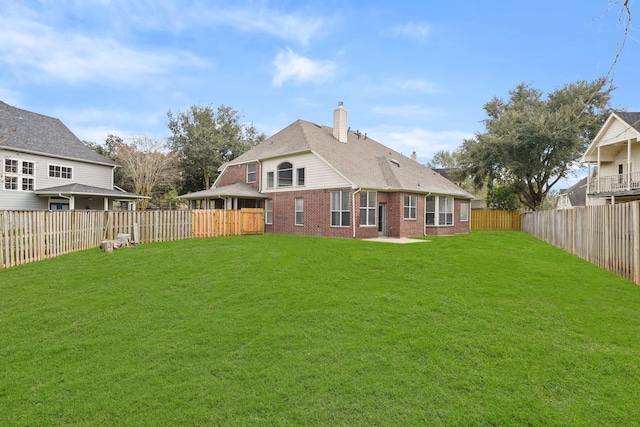 back of house featuring a yard