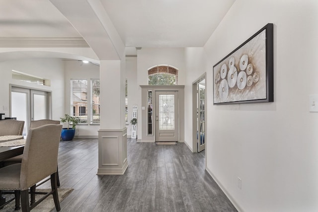 entrance foyer featuring french doors, dark hardwood / wood-style flooring, and decorative columns