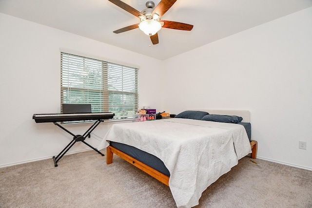 bedroom featuring light colored carpet and ceiling fan