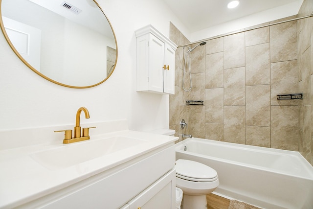 full bathroom featuring vanity, toilet, and tiled shower / bath combo