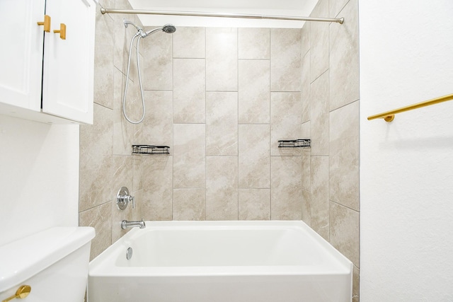 bathroom featuring toilet and tiled shower / bath combo