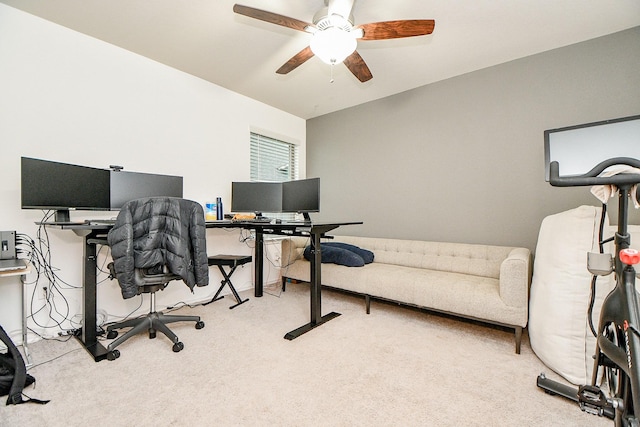 carpeted office space with ceiling fan