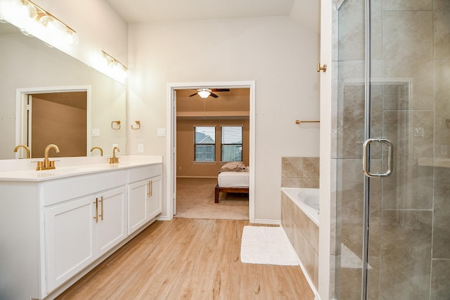 bathroom with hardwood / wood-style flooring, vanity, lofted ceiling, and plus walk in shower