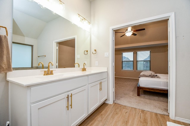 bathroom featuring ceiling fan, lofted ceiling, wood-type flooring, and vanity