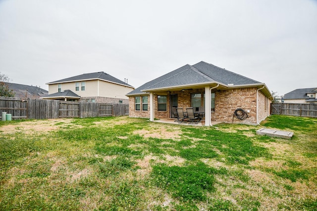 back of house featuring a yard and a patio