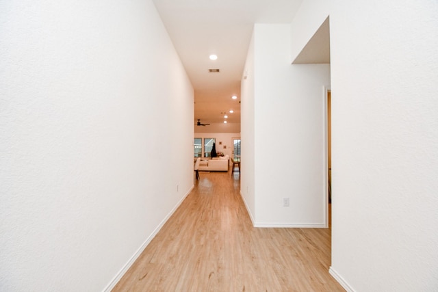 corridor with light hardwood / wood-style flooring