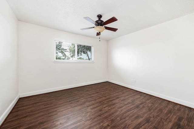 unfurnished room featuring dark wood-type flooring, a textured ceiling, and ceiling fan