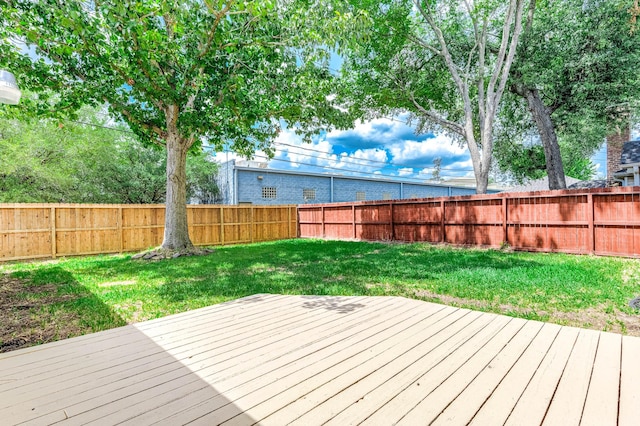 wooden terrace featuring a yard