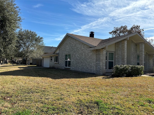 view of side of property featuring a yard and a garage