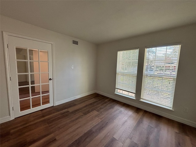 unfurnished room with dark hardwood / wood-style floors