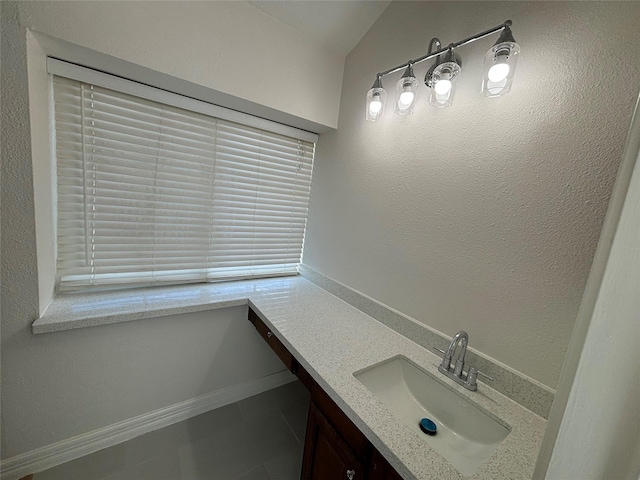 bathroom with vanity and lofted ceiling