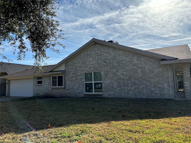 view of side of home with a yard and a garage