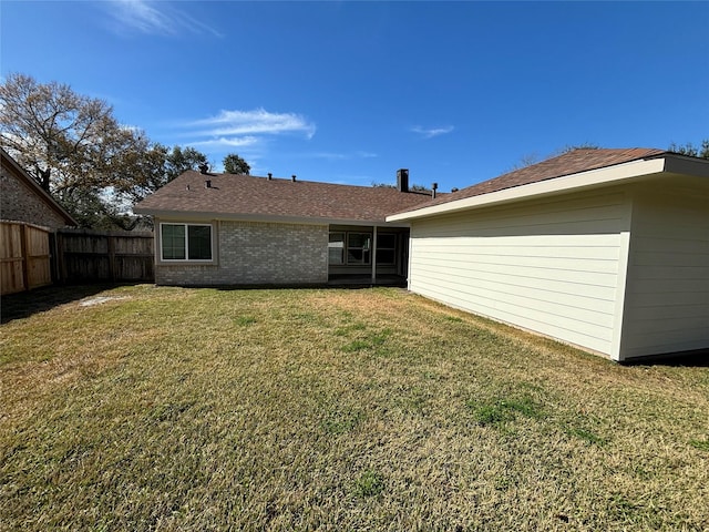 back of house with a lawn