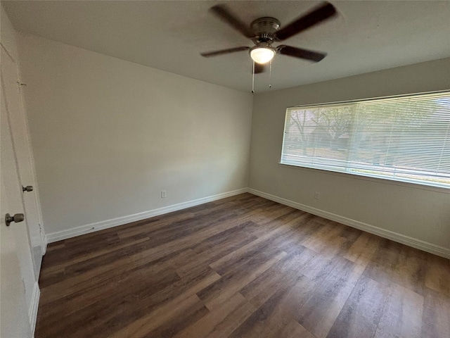 unfurnished room featuring dark wood-type flooring and ceiling fan