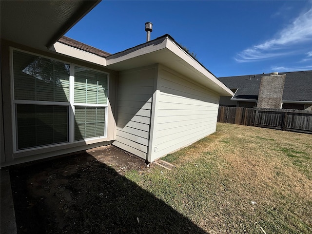 view of side of property with a lawn