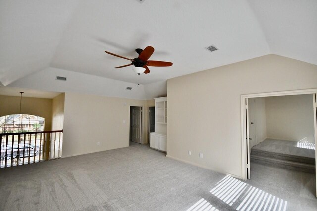 interior space featuring lofted ceiling, light colored carpet, and ceiling fan