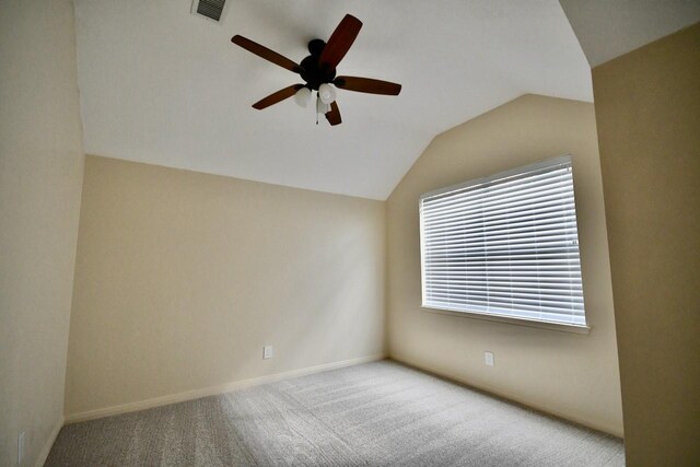 carpeted spare room with ceiling fan and lofted ceiling