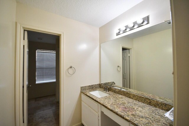 bathroom featuring vanity and a textured ceiling