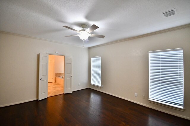 spare room with crown molding, dark hardwood / wood-style floors, a textured ceiling, and ceiling fan