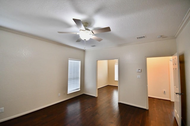 spare room with crown molding, dark wood-type flooring, ceiling fan, and a textured ceiling