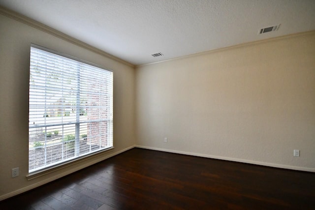 unfurnished room with crown molding, dark hardwood / wood-style floors, and a textured ceiling