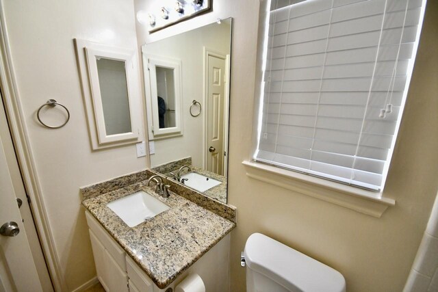 bathroom featuring vanity and toilet