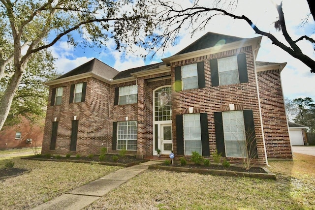 view of front of property featuring a garage and a front lawn