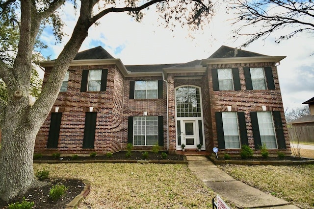 view of front of home featuring a front yard and brick siding