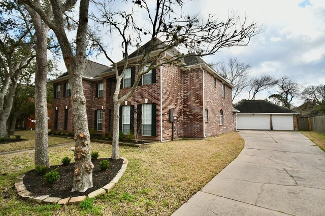 view of property exterior featuring a yard, a garage, and an outdoor structure